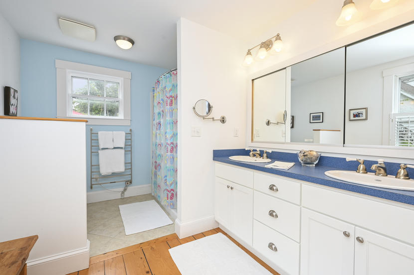 69 Doane Road Harwich Port, MA 02646 - Photo 15 of 38 a bathroom with a double vanity sink and a mirror