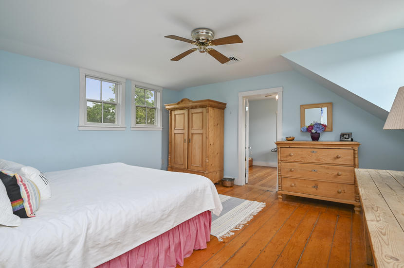 69 Doane Road Harwich Port, MA 02646 - Photo 18 of 38 a bedroom with a bed and wooden floor