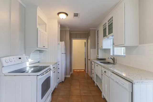 a kitchen with a sink stove and cabinets