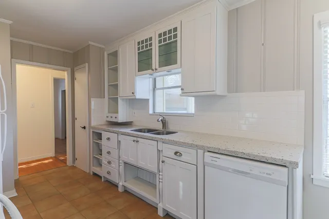 a kitchen with stainless steel appliances granite countertop a sink and a stove top oven