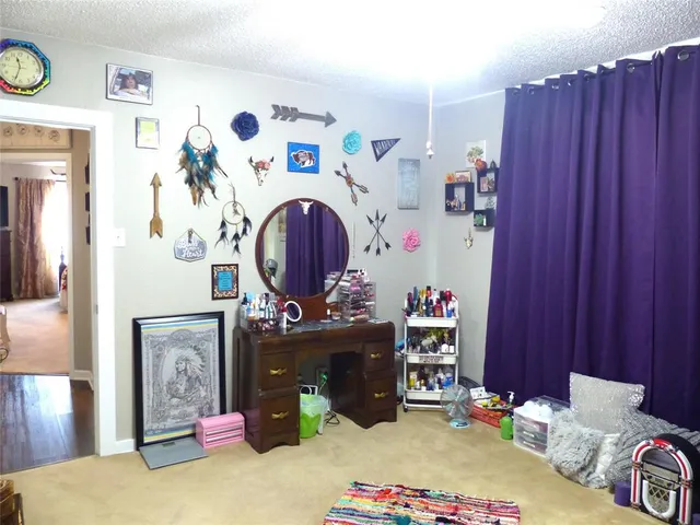 a kitchen with a refrigerator and wooden floor