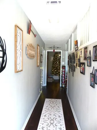 a living room with furniture and a book shelf