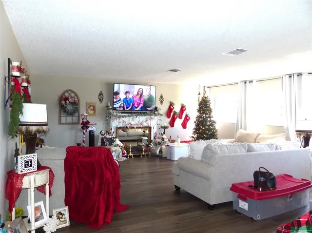 a living room with furniture and wooden floor