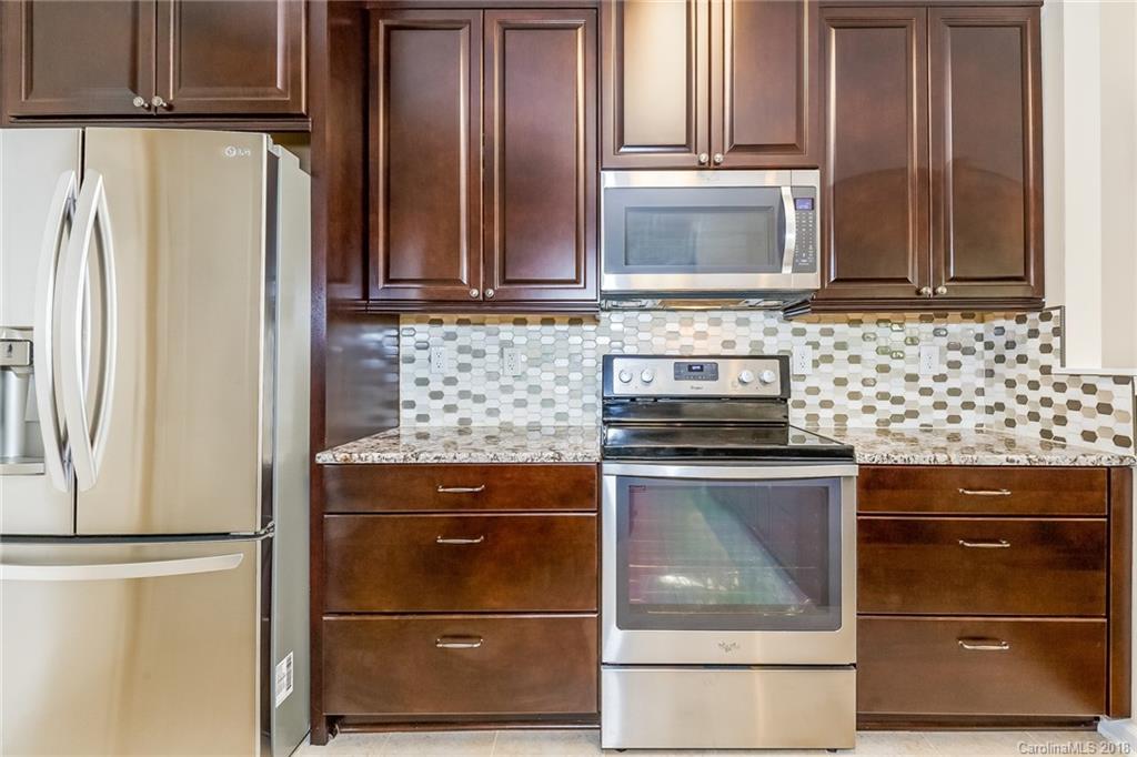 3900 Caliper Place Fort Mill, SC 29708 - Photo 11 of 27 a kitchen with granite countertop white cabinets and stainless steel appliances