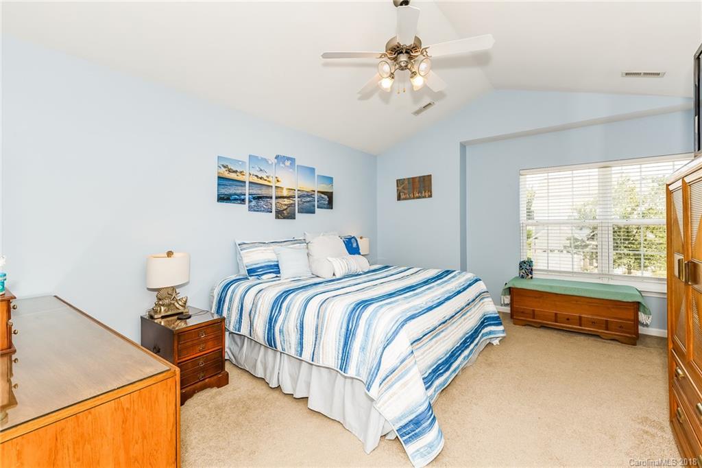 3900 Caliper Place Fort Mill, SC 29708 - Photo 13 of 27 a bedroom with a bed and a chandelier