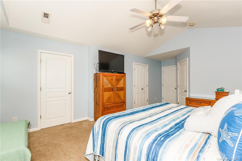 3900 Caliper Place Fort Mill, SC 29708 - Photo 14 of 27 a bedroom with a bed and a chandelier