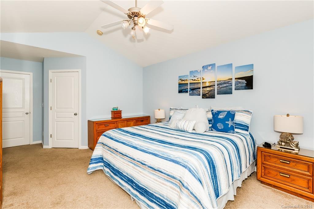3900 Caliper Place Fort Mill, SC 29708 - Photo 15 of 27 a bedroom with bed and a chandelier