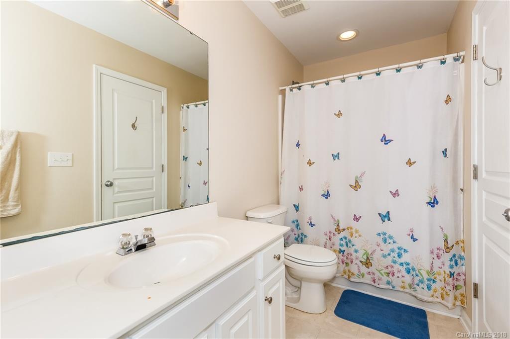 3900 Caliper Place Fort Mill, SC 29708 - Photo 16 of 27 a bathroom with a sink a toilet and shower curtain