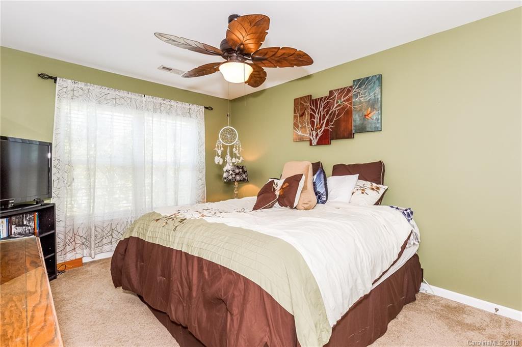 3900 Caliper Place Fort Mill, SC 29708 - Photo 18 of 27 a bedroom with a bed and a flat screen tv