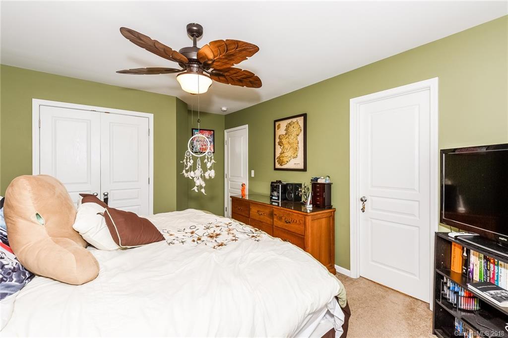 3900 Caliper Place Fort Mill, SC 29708 - Photo 19 of 27 a bedroom with a bed and a flat screen tv