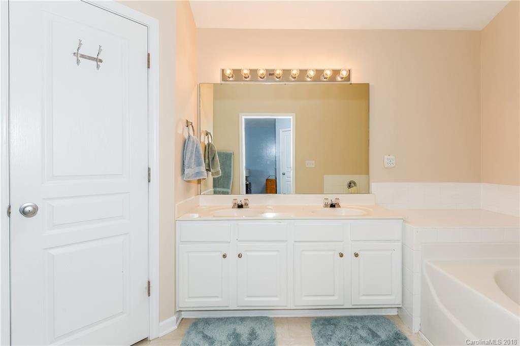 3900 Caliper Place Fort Mill, SC 29708 - Photo 21 of 27 a bathroom with a sink a mirror and a bathtub
