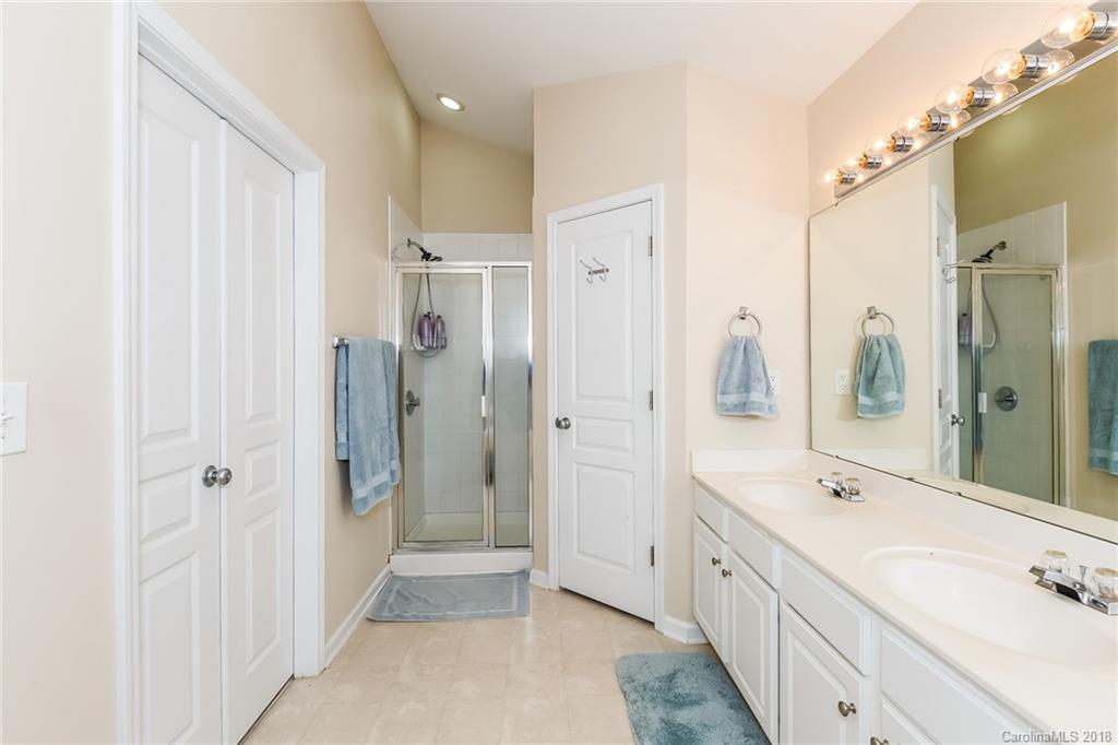 3900 Caliper Place Fort Mill, SC 29708 - Photo 22 of 27 a spacious bathroom with a shower sink and a mirror