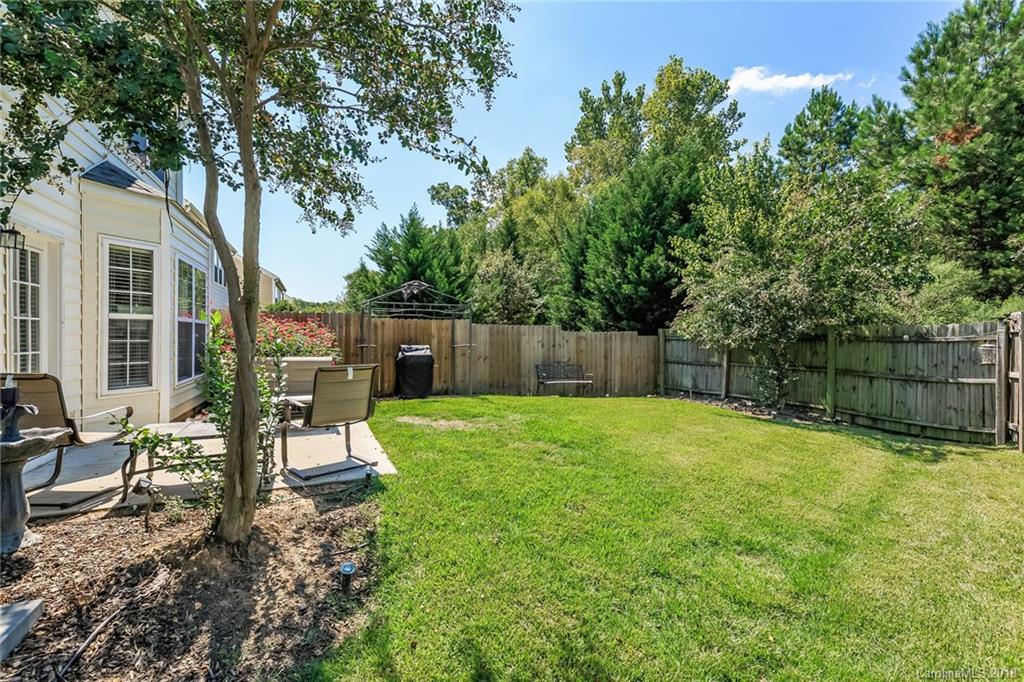 3900 Caliper Place Fort Mill, SC 29708 - Photo 25 of 27 a view of a backyard with wooden fence and a bench