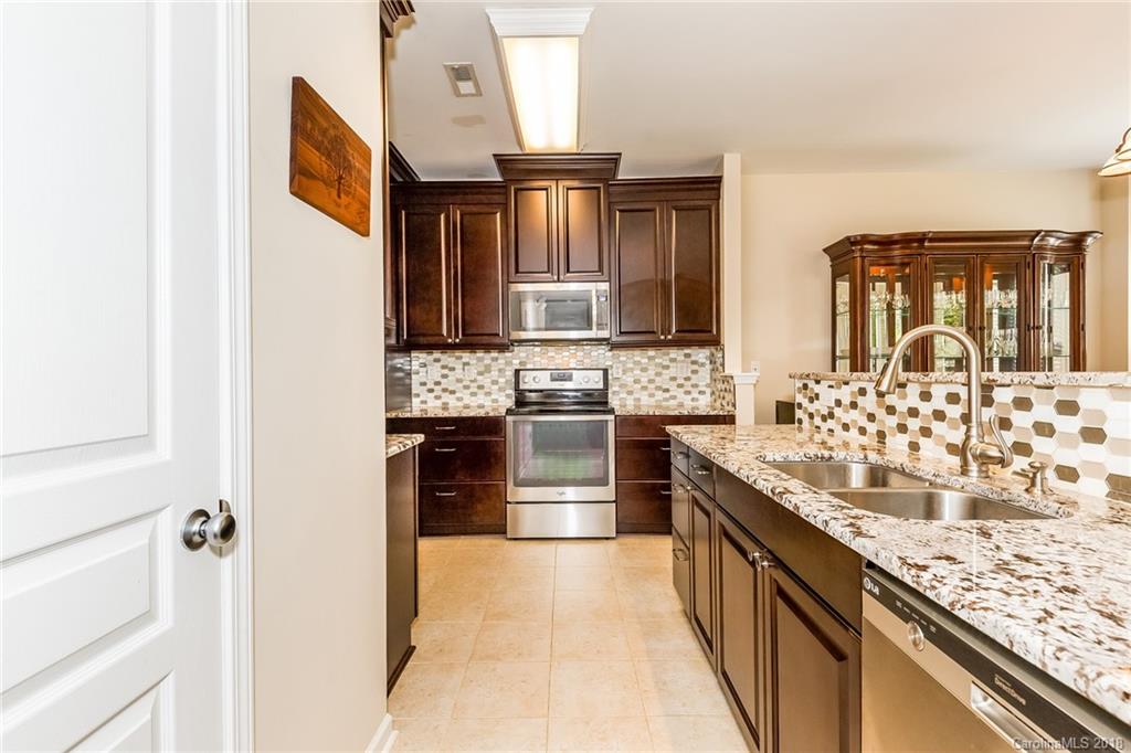 3900 Caliper Place Fort Mill, SC 29708 - Photo 10 of 27 a kitchen with stainless steel appliances granite countertop a stove and a sink