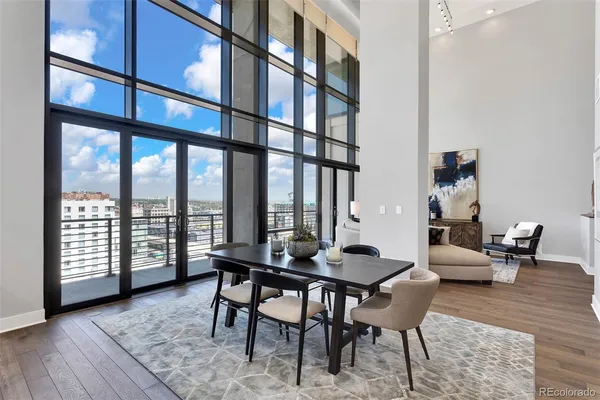 a living room with furniture and a floor to ceiling window