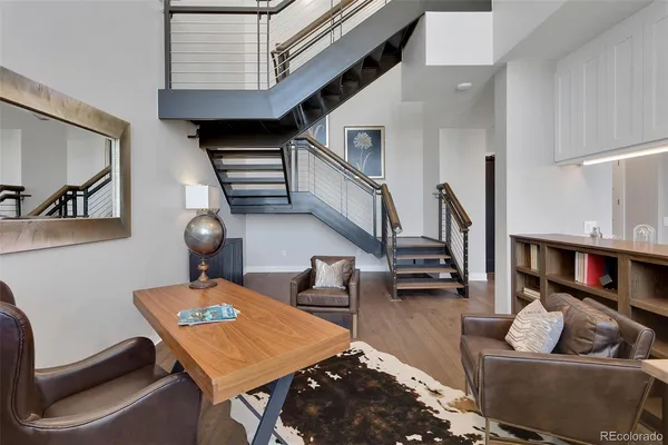 a kitchen with a sink and a stove with white wooden cabinets