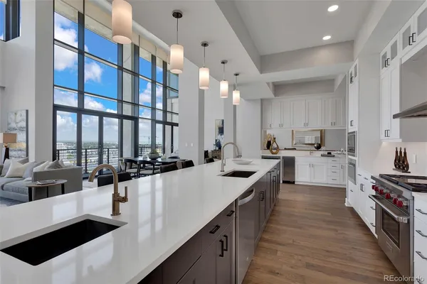 a kitchen with white cabinets and appliances
