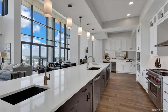 a kitchen with white cabinets and appliances