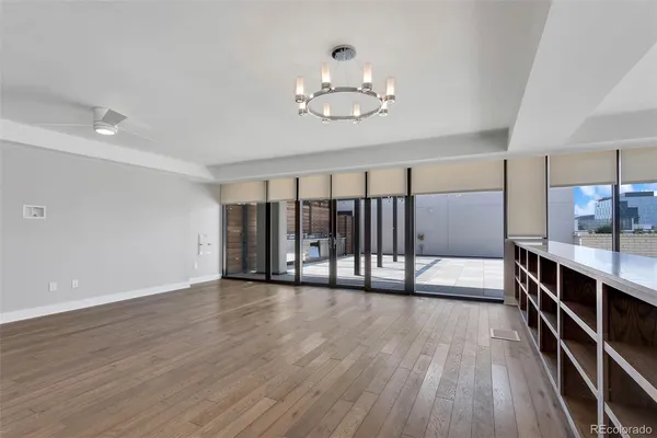 a view of a electric appliances in kitchen and an empty room
