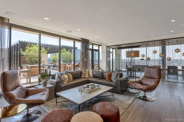 a living room with furniture and a floor to ceiling window