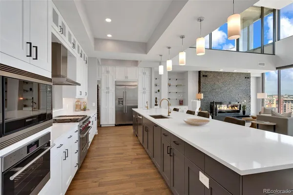 a kitchen with counter top space a sink a window and stainless steel appliances