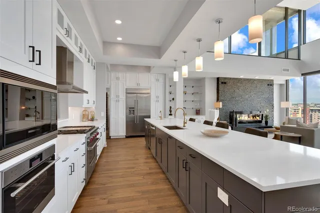 a kitchen with counter top space a sink a window and stainless steel appliances