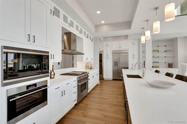 a kitchen with stainless steel appliances kitchen island granite countertop a stove and a sink
