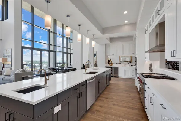 a kitchen with cabinets and chairs