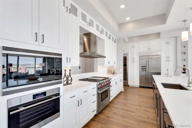 a kitchen with white cabinets and white appliances