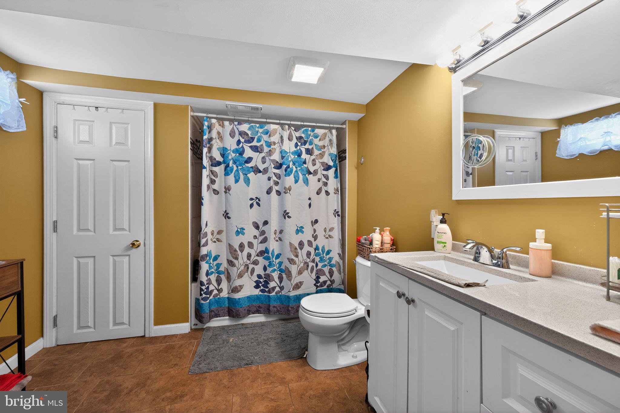 2021 South Brighton Avenue Clementon, NJ 08021 - Photo 12 of 14 a bathroom with a sink a toilet and shower curtain
