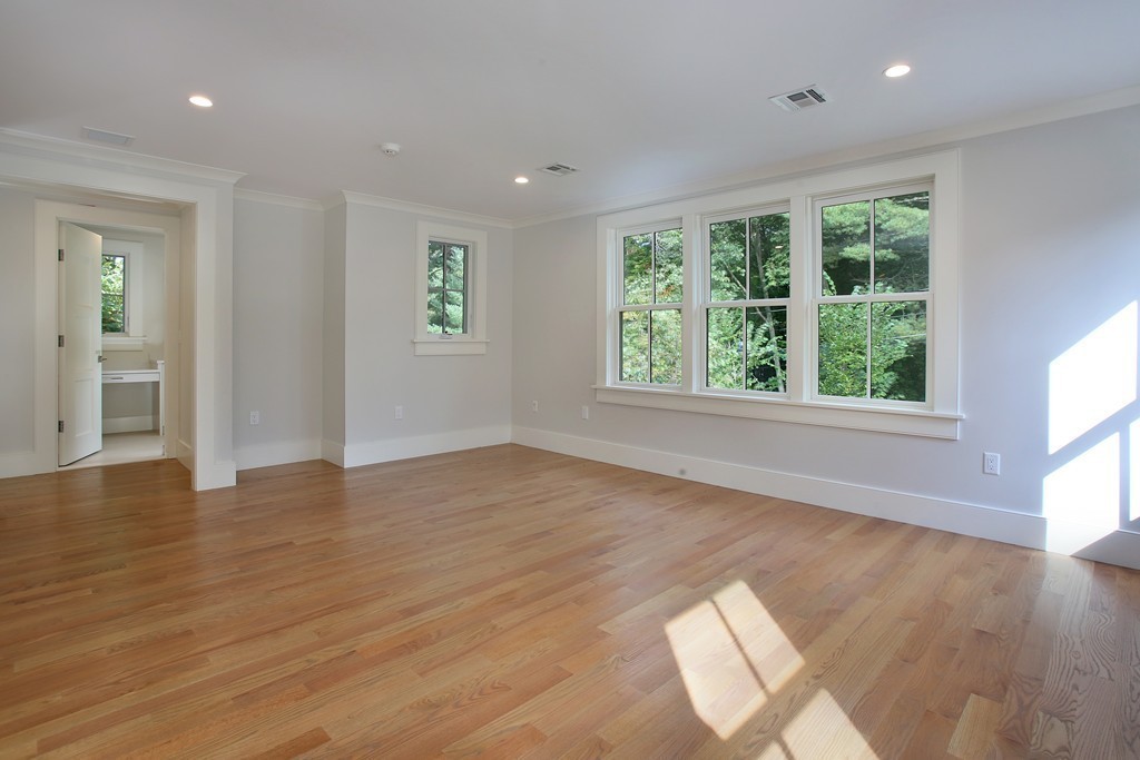 135 Neshobe Road Newton, MA 02468 - Photo 12 of 15 a view of an empty room with wooden floor and a window