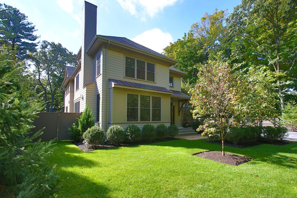 135 Neshobe Road Newton, MA 02468 - Photo 3 of 15 a backyard of a house with plants and a garden