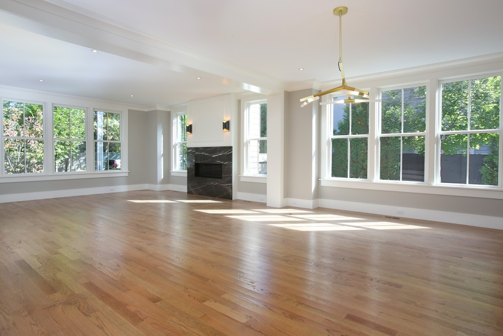 135 Neshobe Road Newton, MA 02468 - Photo 6 of 15 a view of an empty room with wooden floor and a window