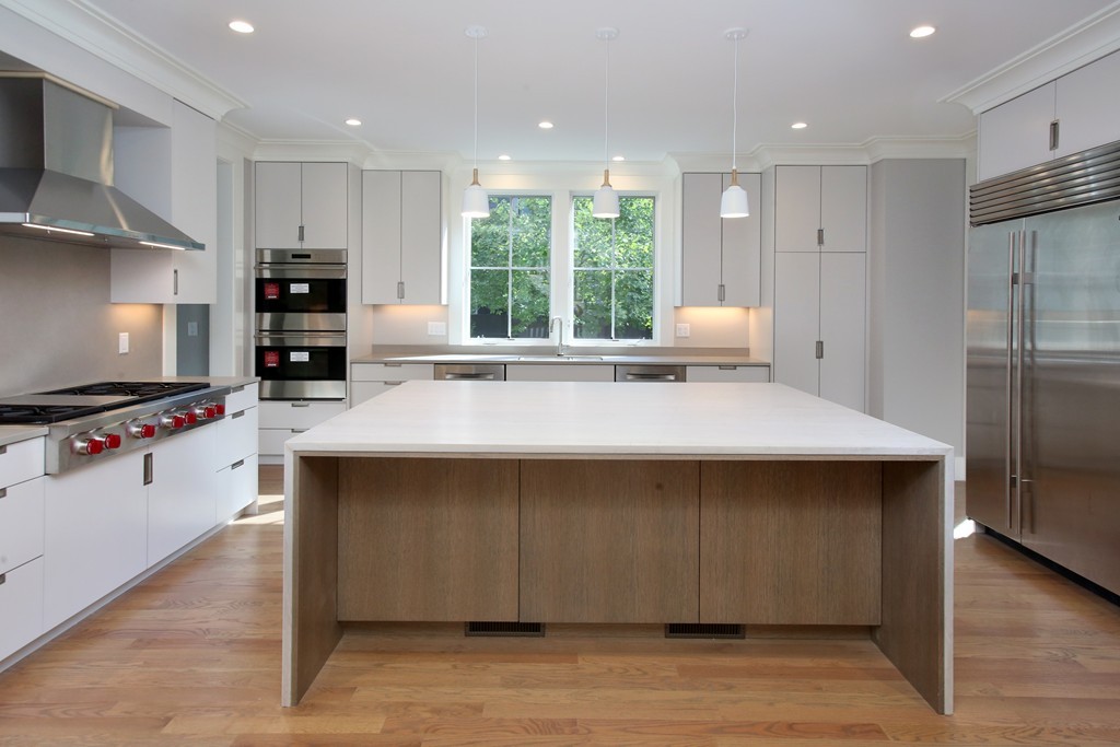 135 Neshobe Road Newton, MA 02468 - Photo 7 of 15 a kitchen with a sink a counter top space stainless steel appliances and a window