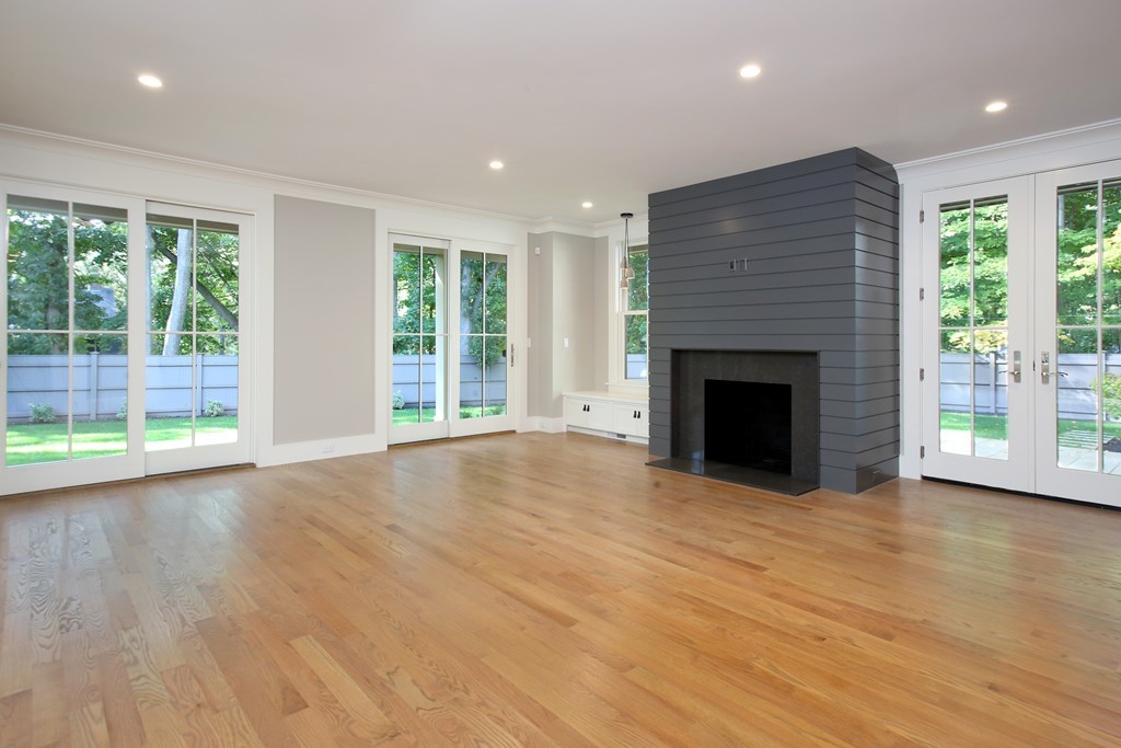 135 Neshobe Road Newton, MA 02468 - Photo 8 of 15 a view of empty room with wooden floor and fireplace