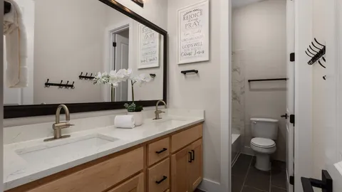 a bathroom with a toilet sink and mirror