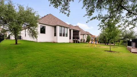a front view of a house with a yard and trees