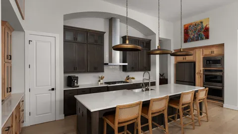 a kitchen with a dining table chairs sink and stove