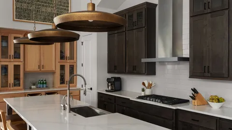 a kitchen with stainless steel appliances a stove a sink and cabinets