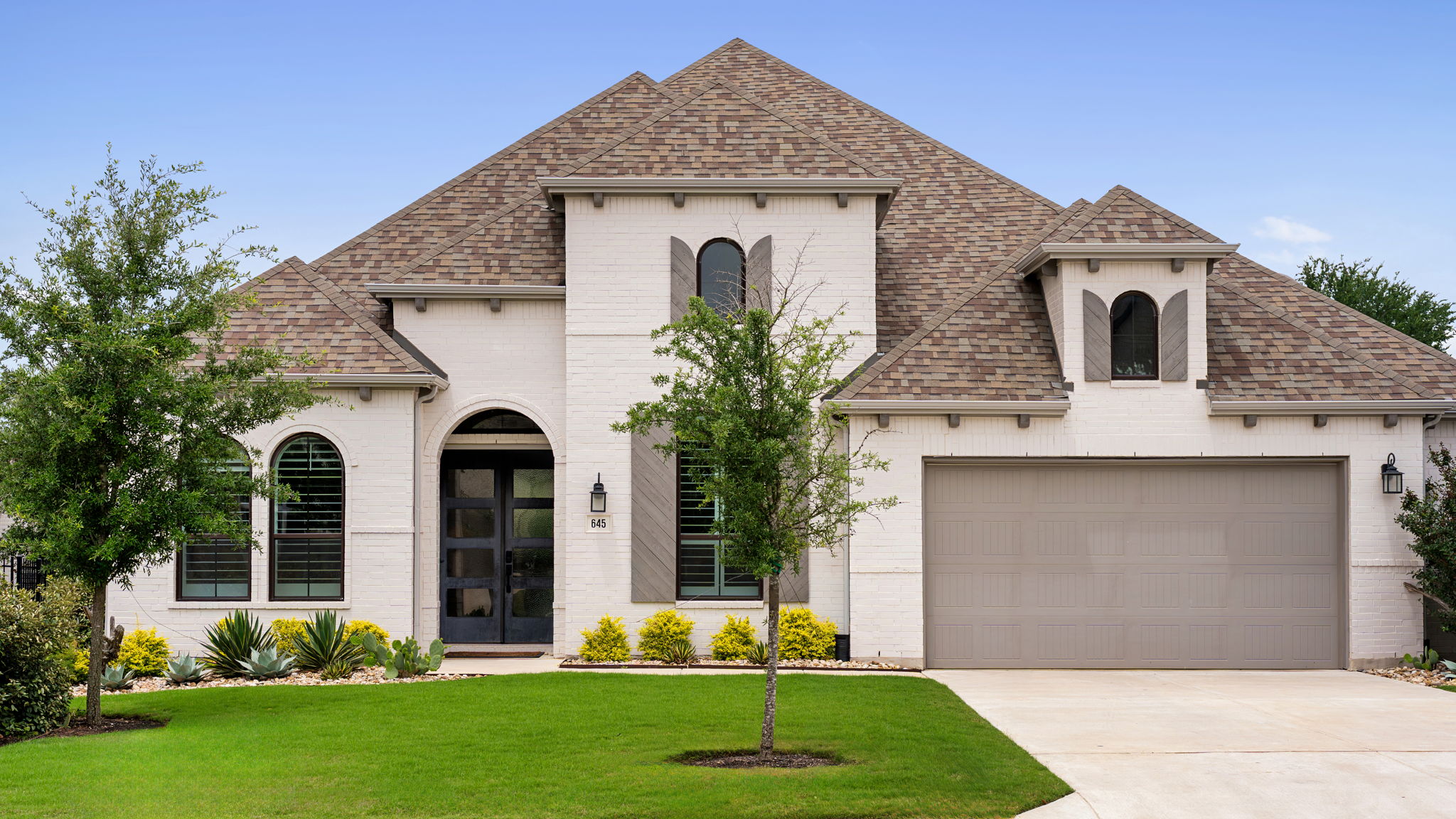 645 Two Creeks Lane Austin, TX 78737 - Photo 7 of 37 a front view of a house with garden