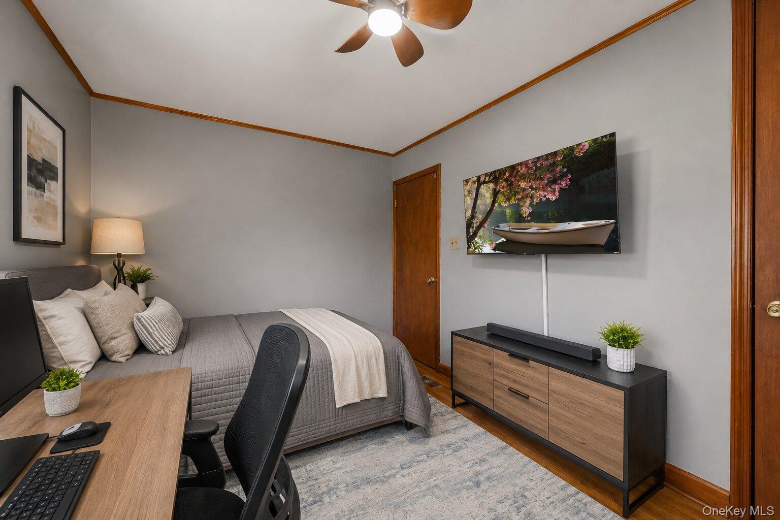 49 Chase Road Wallkill, NY 12589 - Photo 15 of 32 Virtually Staged Bedroom and Workspace: Additional view of the versatile bedroom featuring a bed, dresser, workstation, hardwood floors, and multiple windows.