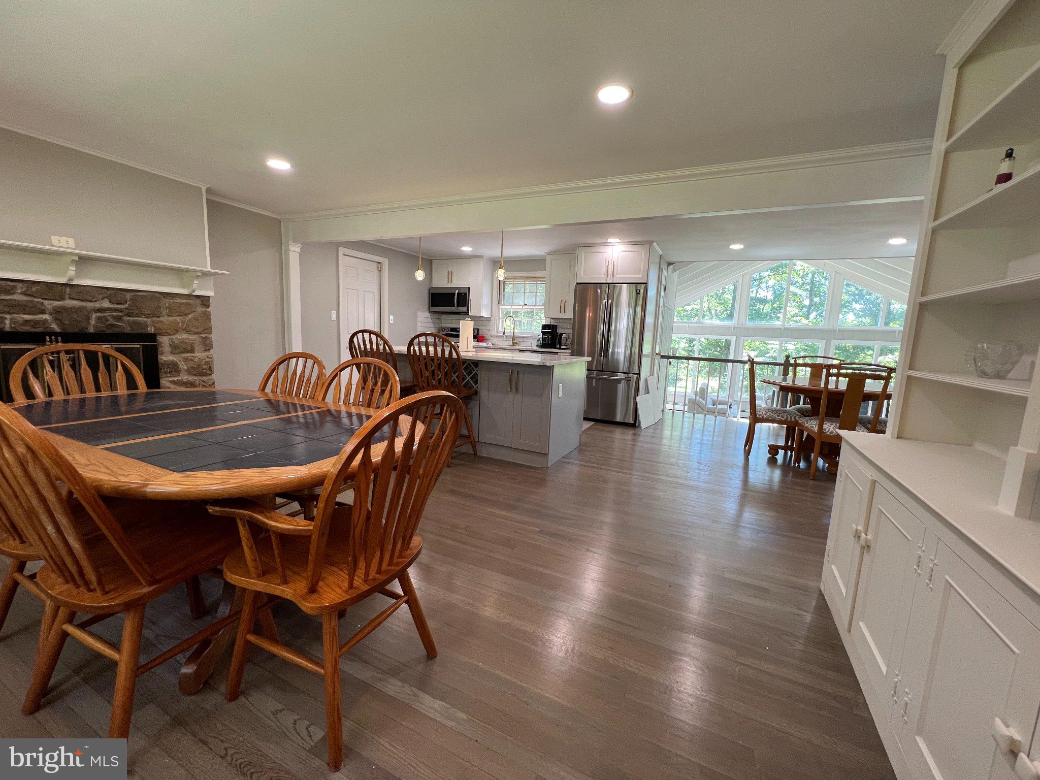 504 Swartley Road Hatfield, PA 19440 - Photo 11 of 32 a dining room with furniture wooden floor and a floor to ceiling window
