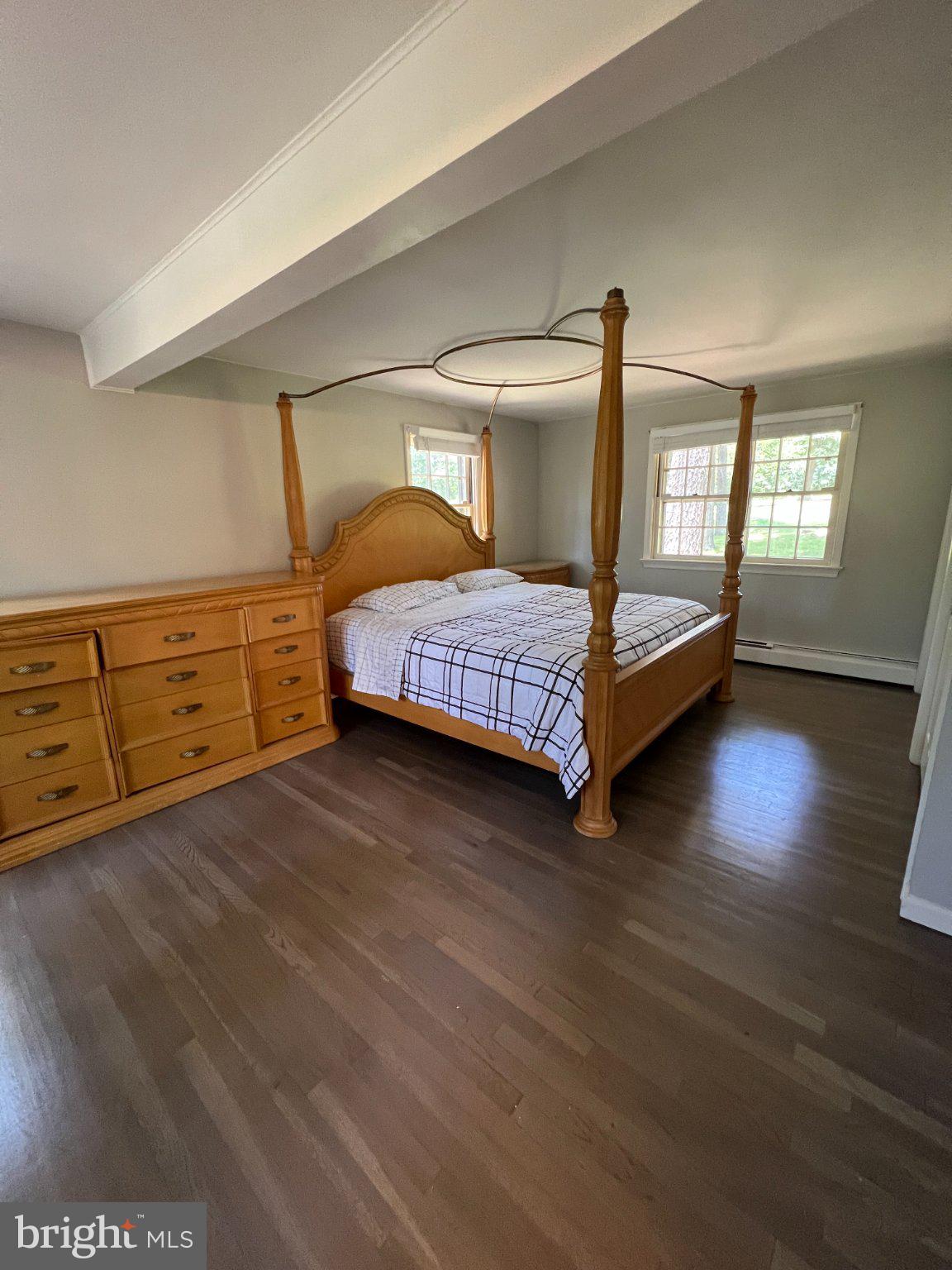 504 Swartley Road Hatfield, PA 19440 - Photo 25 of 32 a spacious bedroom with a bed and wooden floor