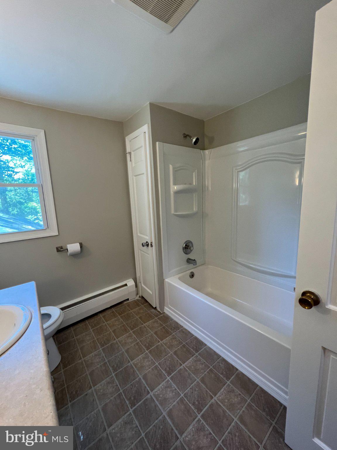 504 Swartley Road Hatfield, PA 19440 - Photo 28 of 32 a bathroom with a toilet and a bathtub