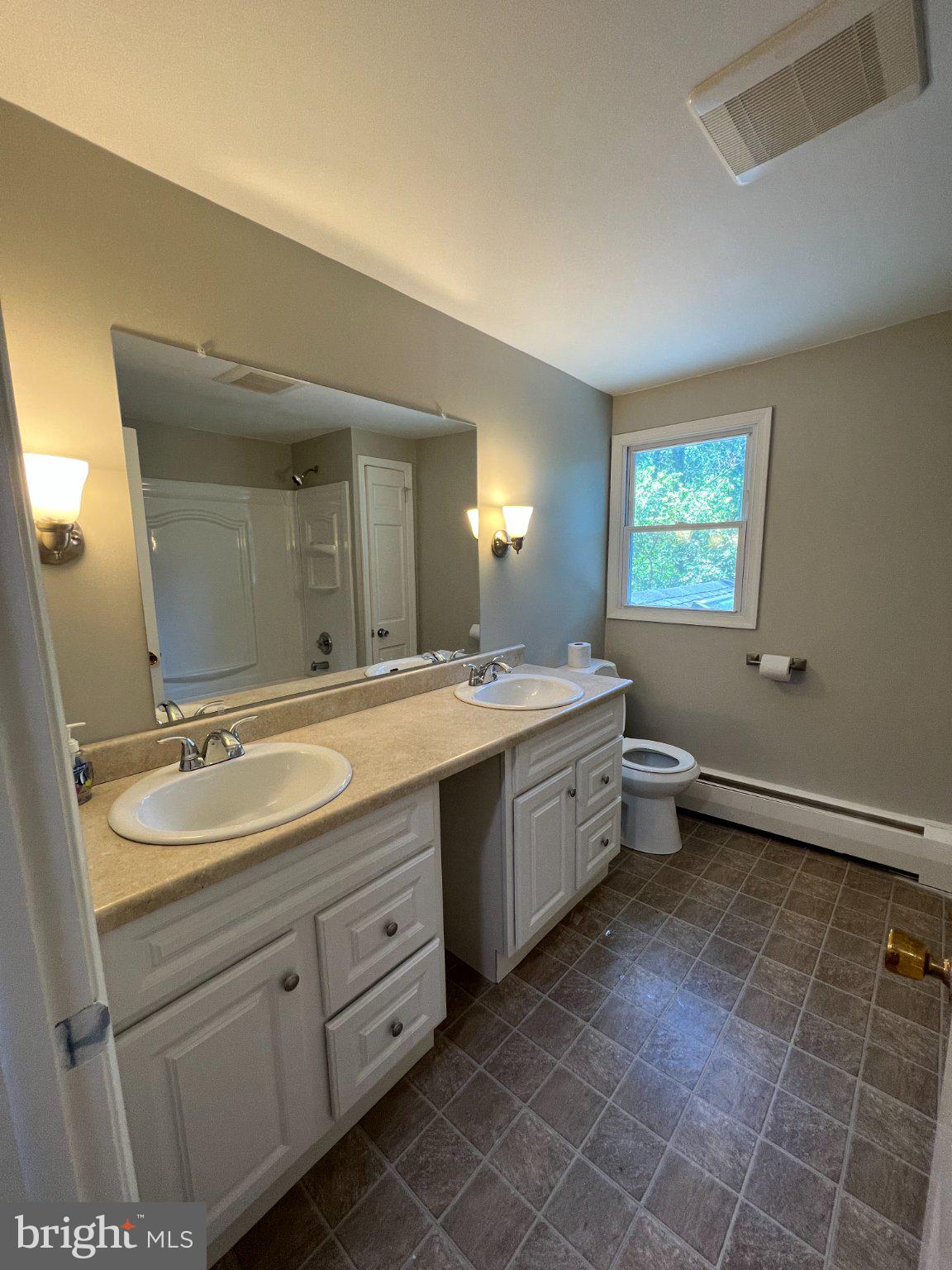 504 Swartley Road Hatfield, PA 19440 - Photo 29 of 32 a bathroom with a double vanity sink a mirror and a toilet