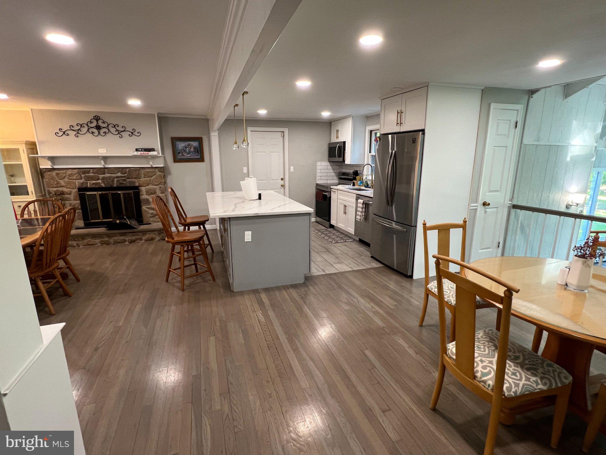 504 Swartley Road Hatfield, PA 19440 - Photo 8 of 32 a living room with stainless steel appliances furniture wooden floor and a kitchen view