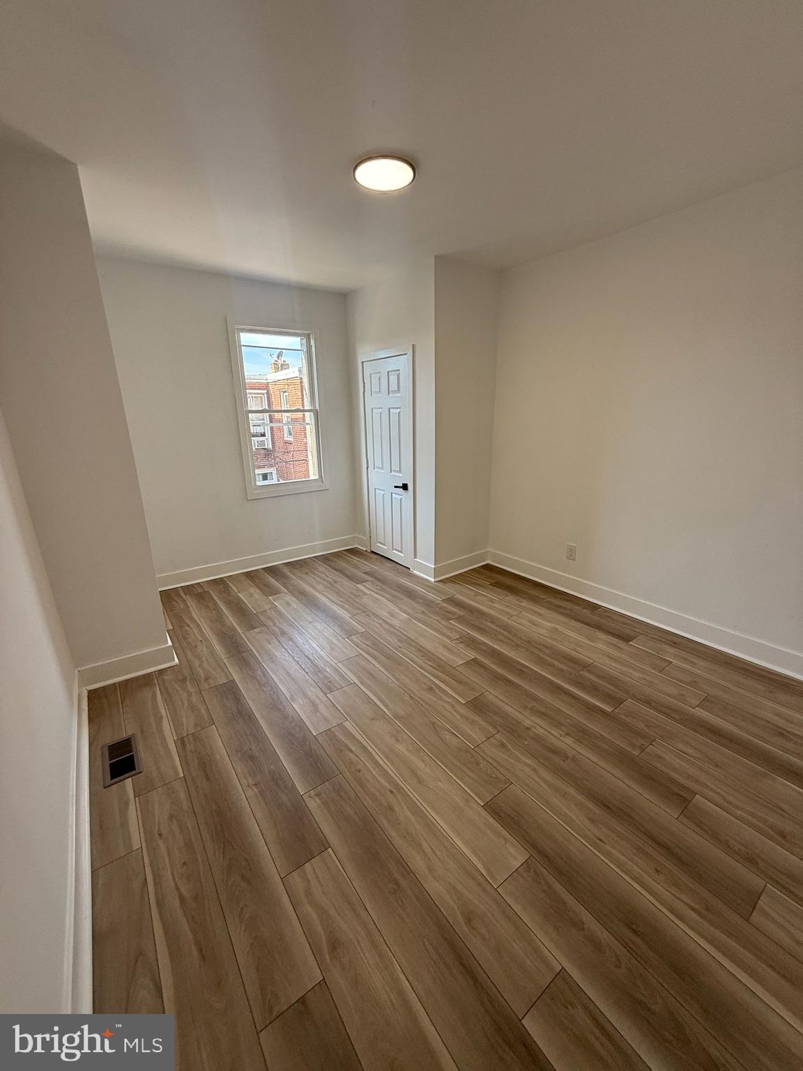 894 Sanger Street Philadelphia, PA 19124 - Photo 20 of 35 wooden floor in an empty room with a window