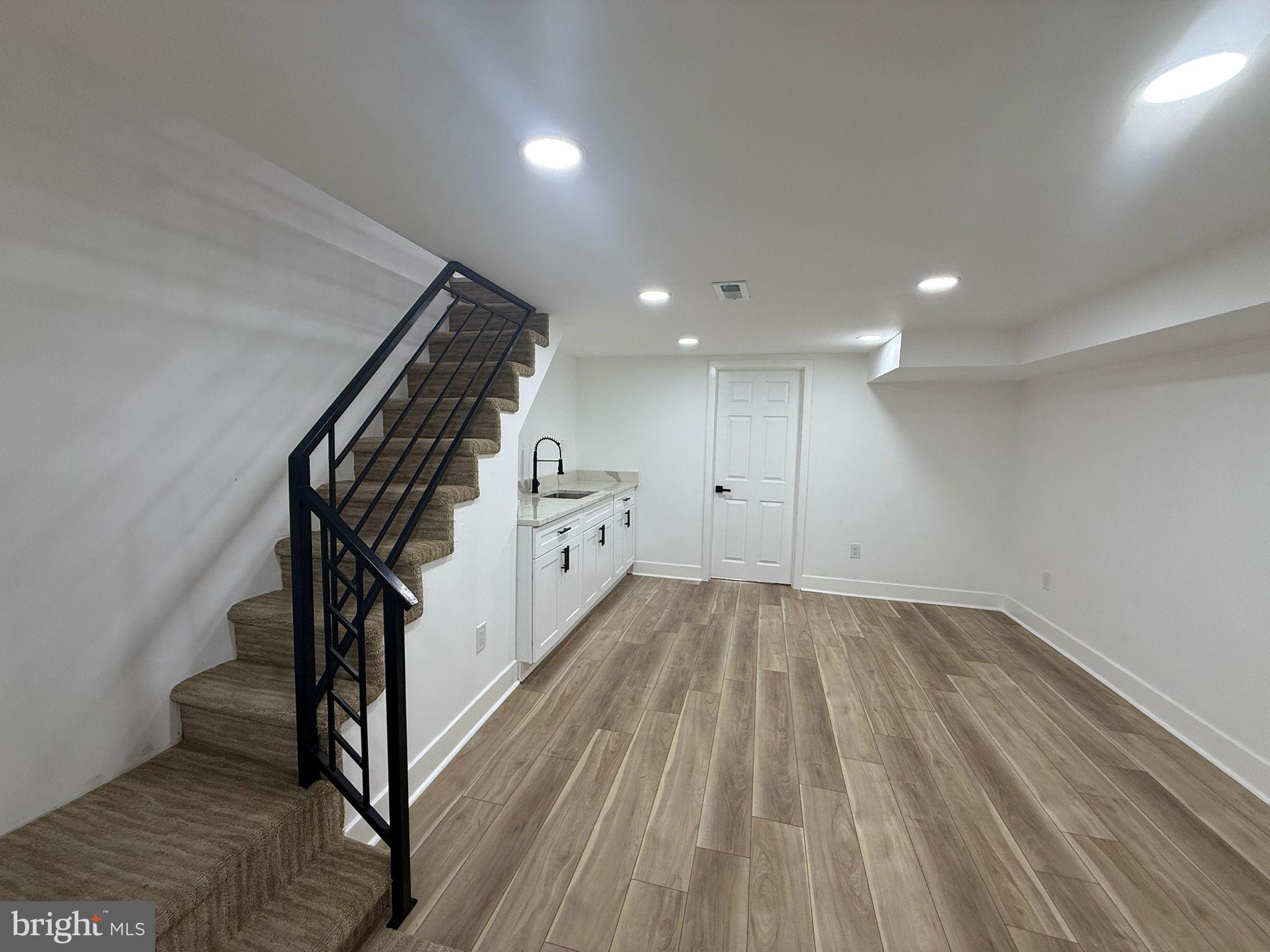 894 Sanger Street Philadelphia, PA 19124 - Photo 26 of 35 a view of an empty room with wooden floor and stairs