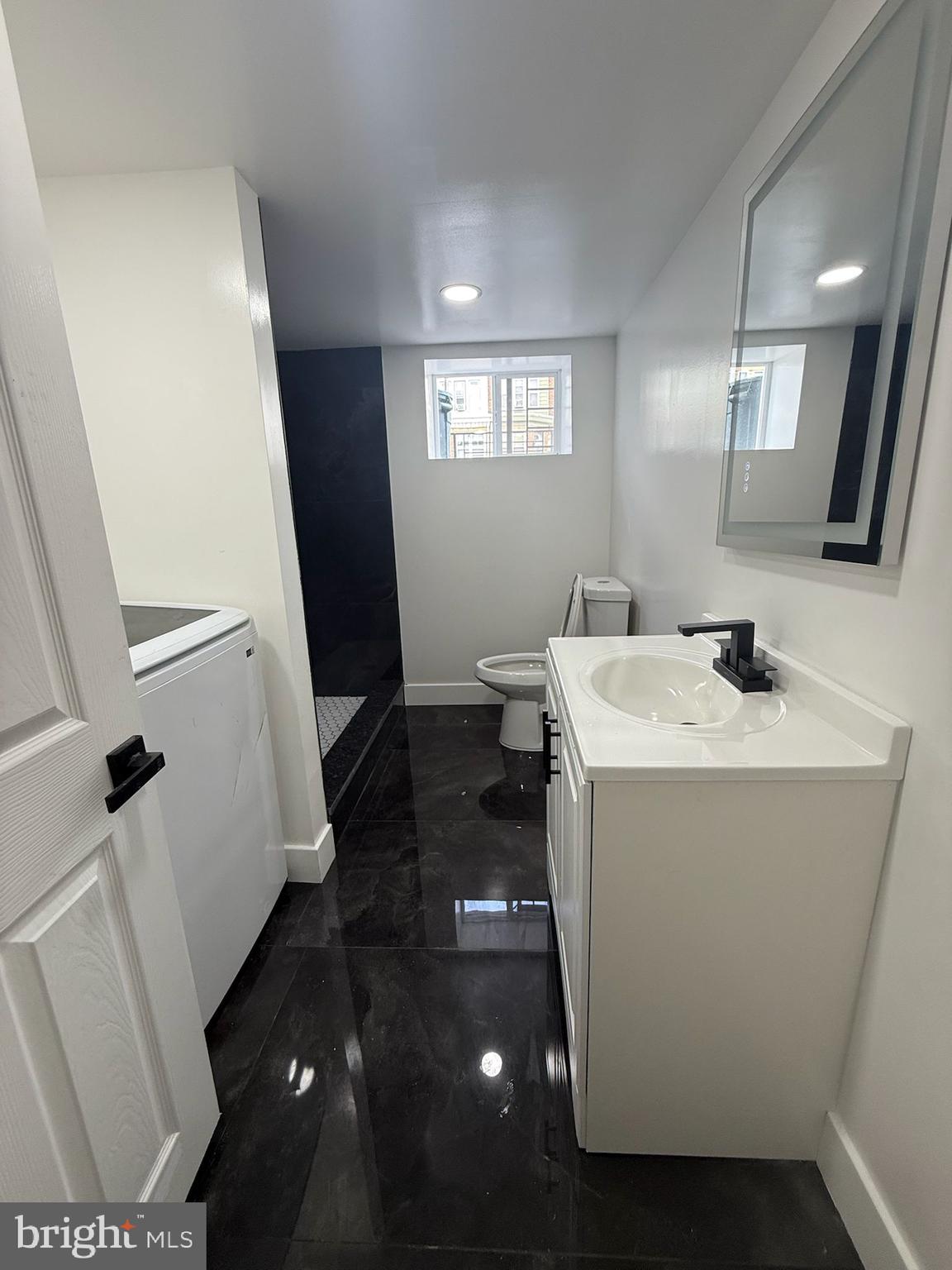 894 Sanger Street Philadelphia, PA 19124 - Photo 28 of 35 a bathroom with sink and mirror