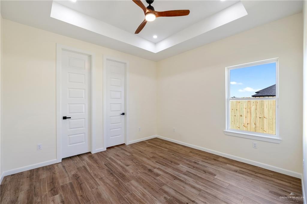 1602 Helen Drive Weslaco, TX 78596 - Photo 16 of 32 wooden floor in an empty room with a window